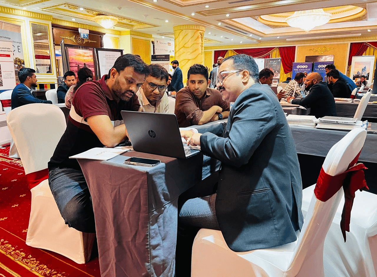 Sanjay Pan in conversation with clients at a property event